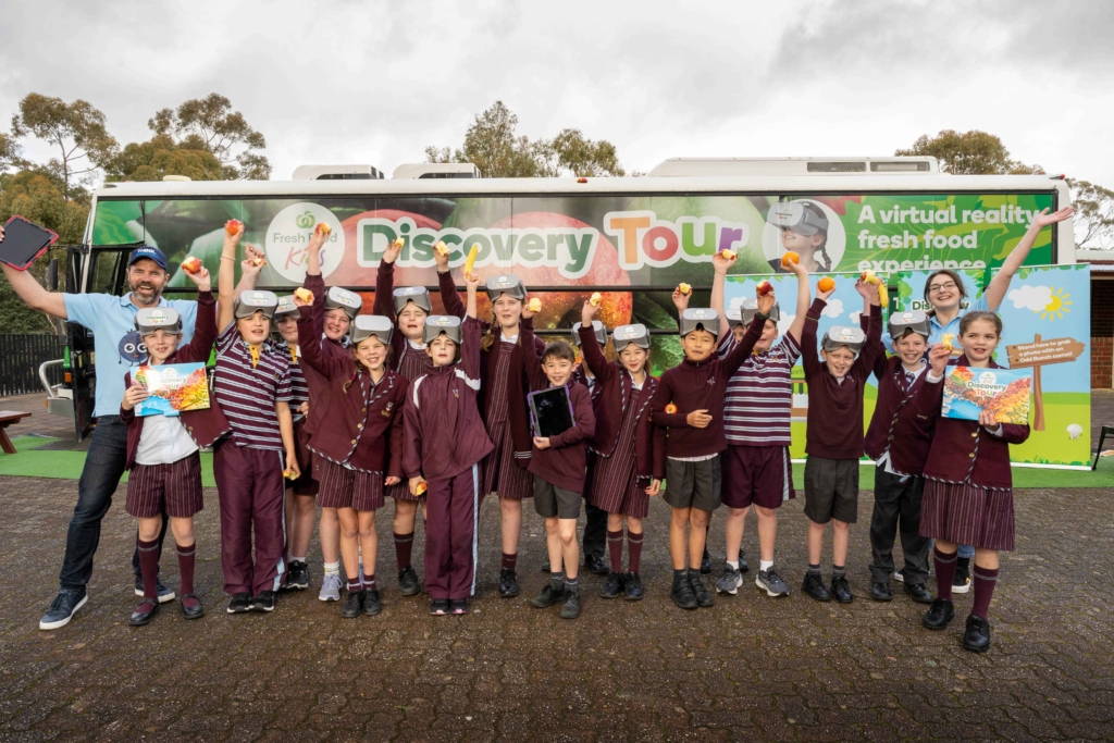 A group of students with Tim and Jess standing outside the Think Digital Coach after using virtual reality in agriculture as part of the Woolworths Discovery Tour program